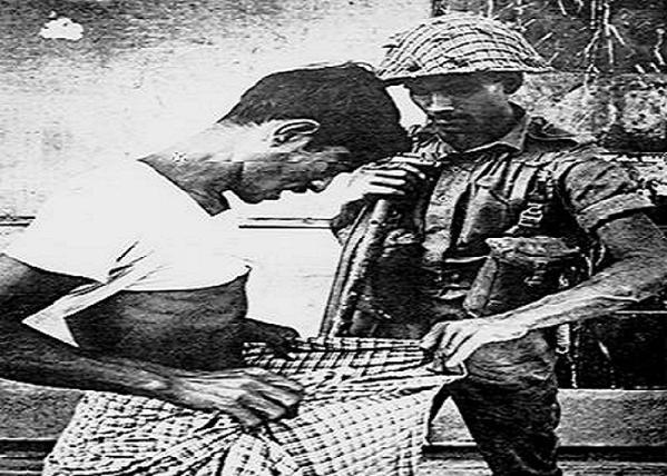 A pakistani soldier checks if a man is circumcised or not to identify his religion.